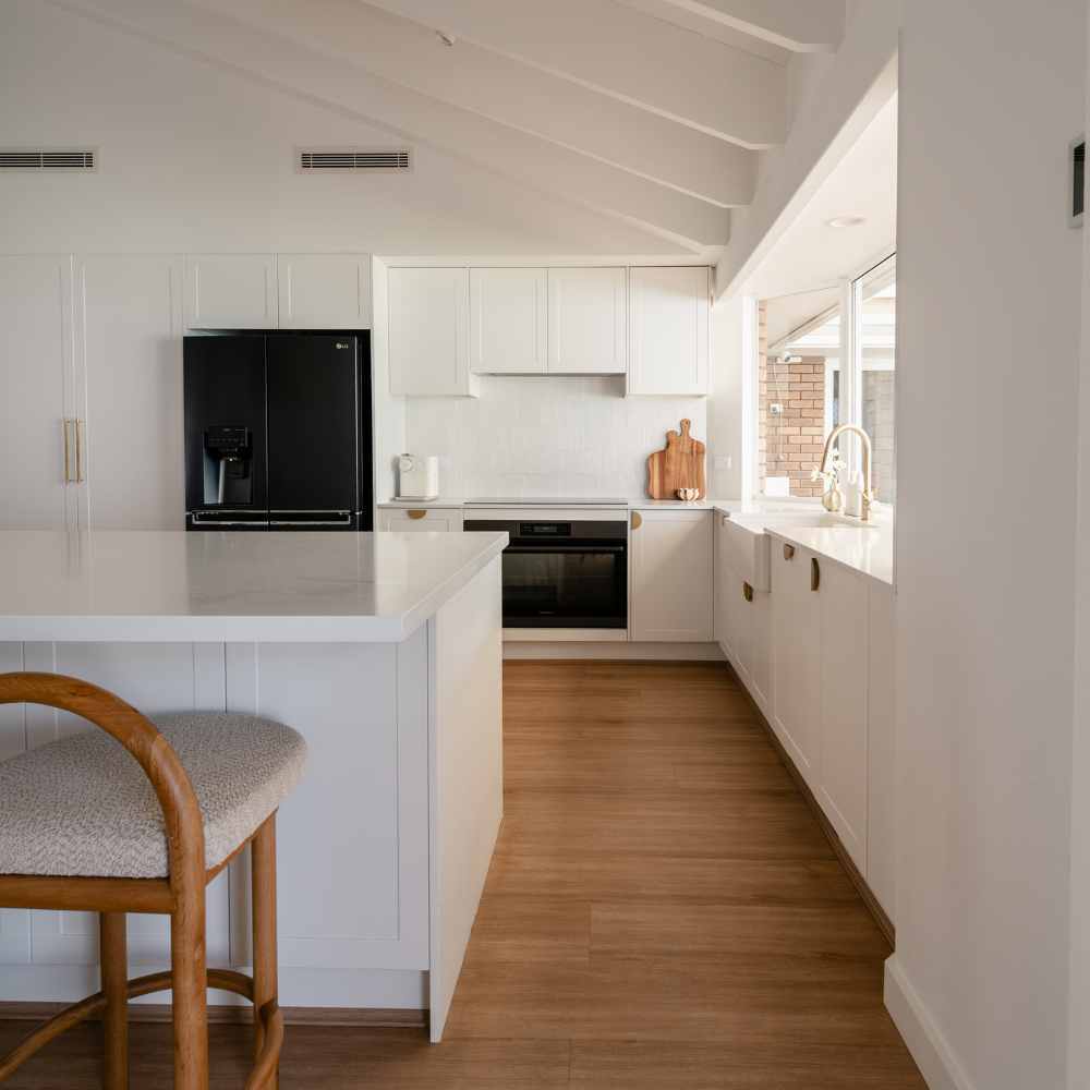 White, bright and beautiful - Michelle's Kitchen Renovation raked white-beamed ceiling, island, dining. The "coastal resort feel" shot.